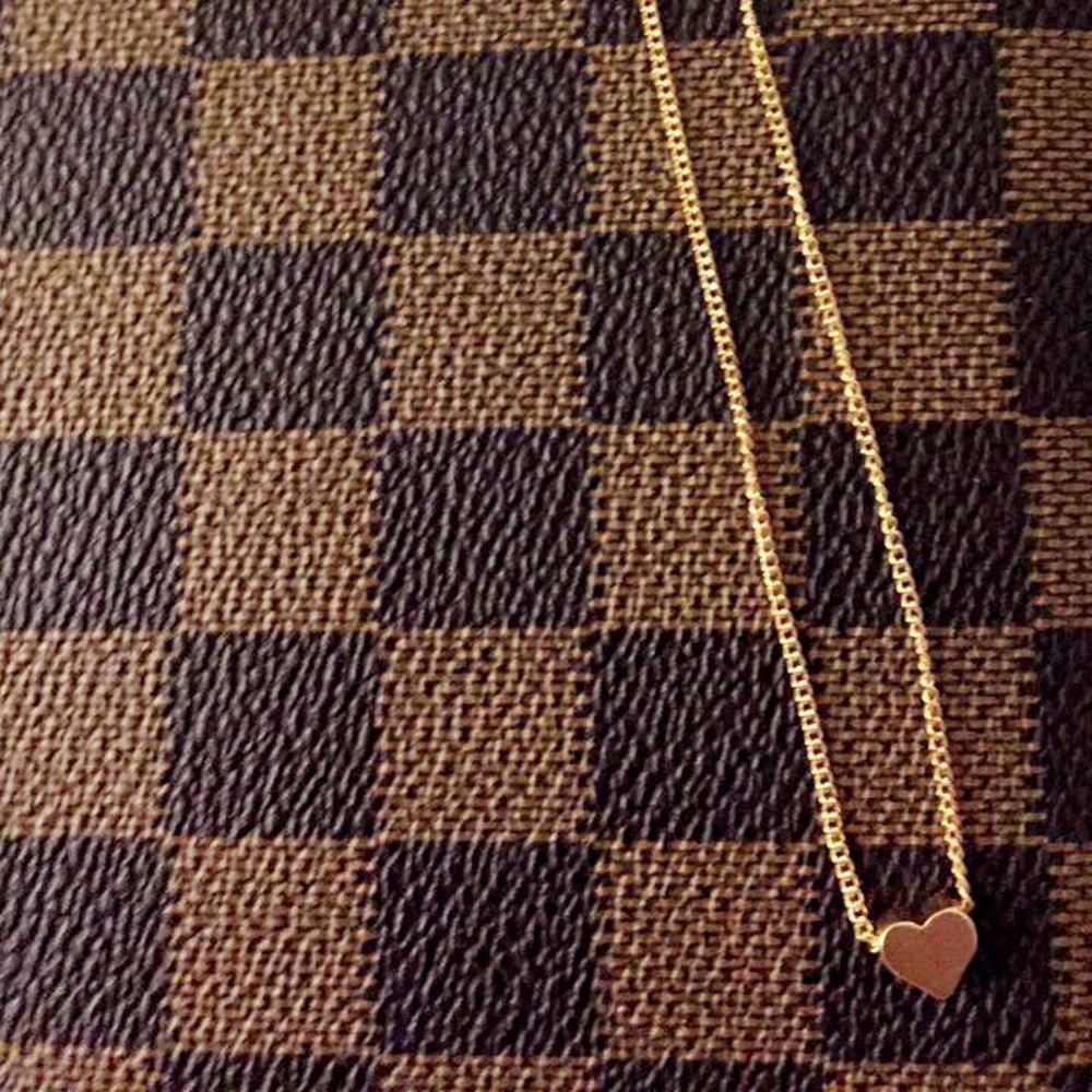 Gold choker style rope necklace with heart